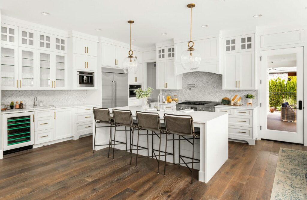 A modern, renovated kitchen with new countertops and backsplash