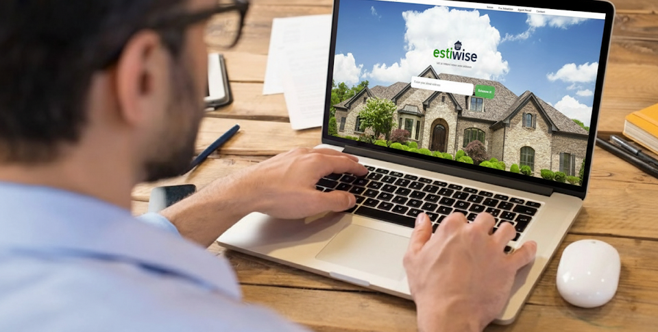 Real Estate Agent using the Estiwise Portal on a laptop